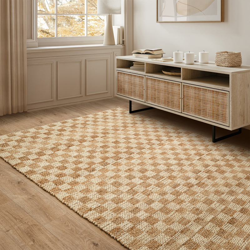 Room with a checkerboard jute rug beneath a cane sideboard